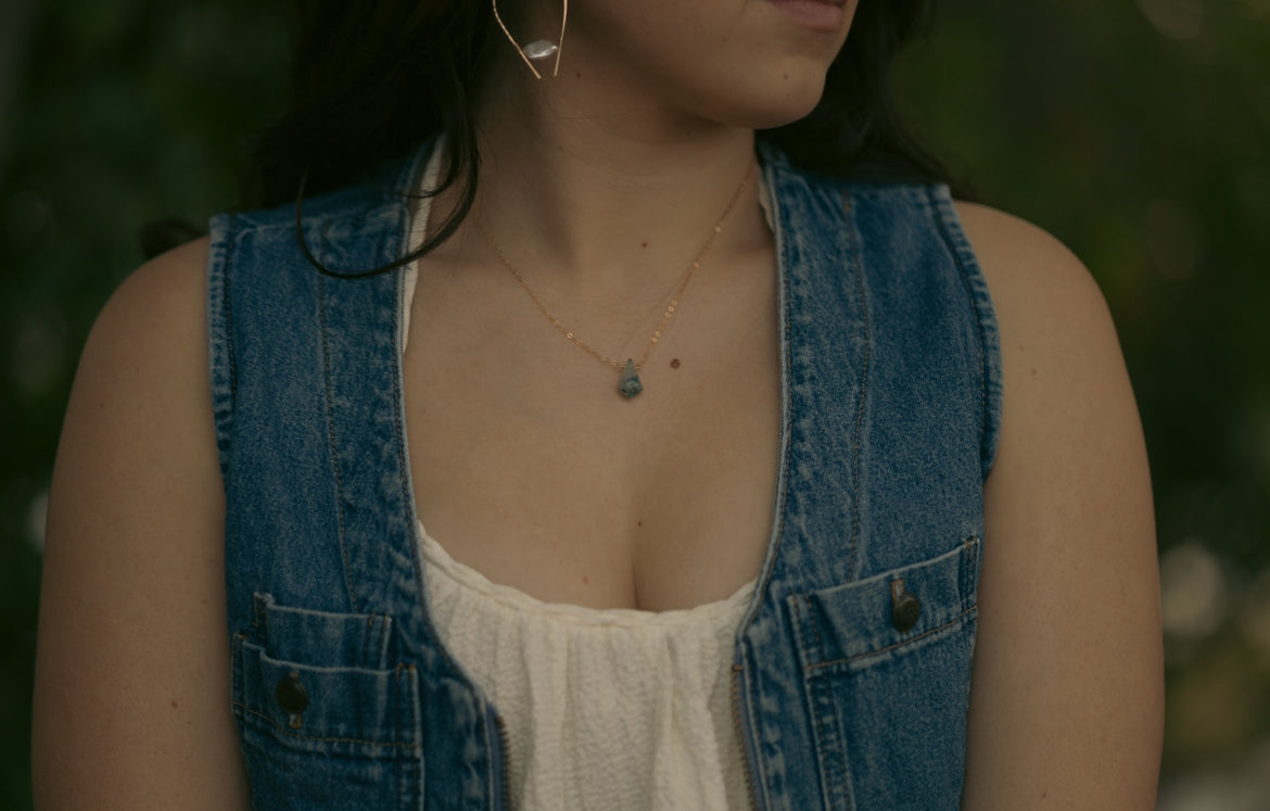 woman wearing a 14k gold filled cable chain necklace with a green and white moss agate pendant.